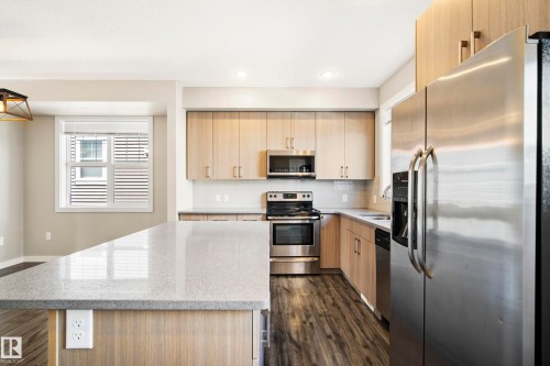 Kitchen from Balcony Door - #82 2803 James Mowatt Trail Sw, Edmonton, AB - Indoor Photo Showing Kitchen With Stainless Steel Kitchen