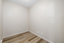 Neutral-toned walls, wood-finish flooring, and white trim - 