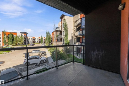 Private balcony featuring a concrete surface and a glass railing with black metal posts - #207 304 Amblside Li Sw Sw, Edmonton, AB - Outdoor