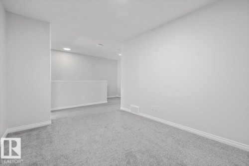 Soft gray carpeting and light gray wall finishes - 1014 Daniels Loop Sw, Edmonton, AB - Indoor Photo Showing Other Room