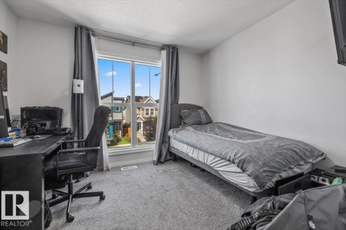 Recessed window with white trim, light gray walls, and gray carpet - 1014 Daniels Loop Sw, Edmonton, AB - Indoor Photo Showing Bedroom