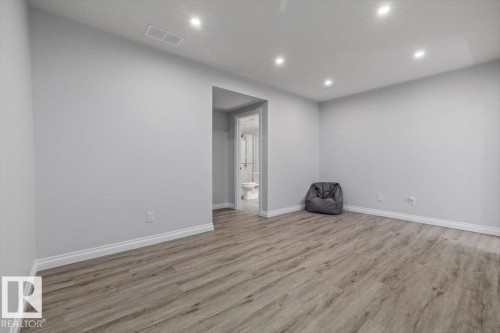 Recessed lighting, wood-finish flooring, light grey wall paint, and white trim - 1014 Daniels Loop Sw, Edmonton, AB - Indoor