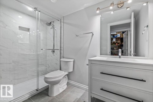 Glass-enclosed shower with tiled walls and built-in niche - 1014 Daniels Loop Sw, Edmonton, AB - Indoor Photo Showing Bathroom