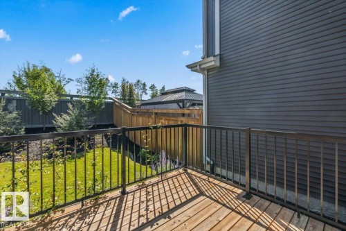 Wood-finish deck with black metal railing - 1014 Daniels Loop Sw, Edmonton, AB - Outdoor With Deck Patio Veranda With Exterior