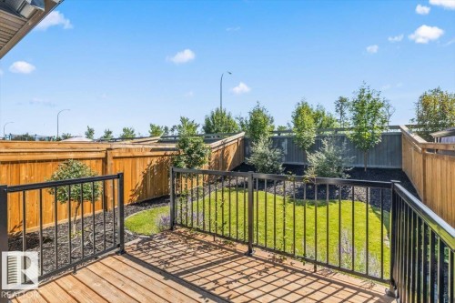 Wood-finish deck with black metal railing - 1014 Daniels Loop Sw, Edmonton, AB - Outdoor With Deck Patio Veranda