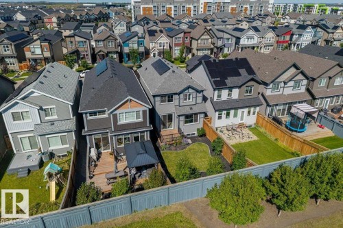 Rear exterior featuring a wood deck, fenced backyard, and solar panels - 1014 Daniels Loop Sw, Edmonton, AB - Outdoor