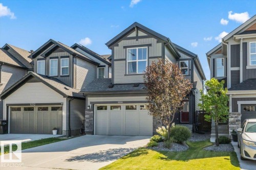 Contemporary exterior with mixed siding, stone accents, and a two-car garage - 1014 Daniels Loop Sw, Edmonton, AB - Outdoor With Facade