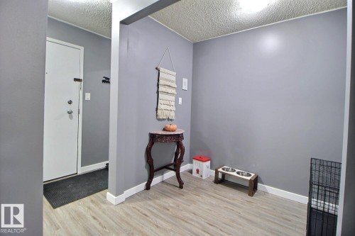 Wood-finish flooring with white trim and a neutral paint palette - #304 14004 26 St Nw, Edmonton, AB - Indoor