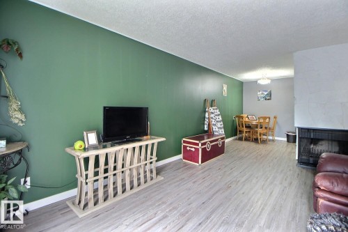 Light wood-finish flooring complements the interior wall colors - #304 14004 26 St Nw, Edmonton, AB - Indoor