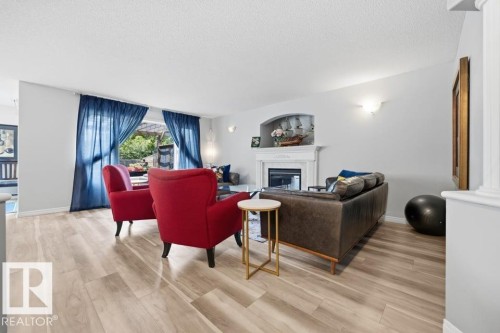 22 Bonin, Beaumont, AB - Indoor Photo Showing Other Room With Fireplace
