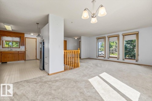 Open-concept living area with carpeted flooring - 4427 Payne Avenue, Onoway, AB - Indoor Photo Showing Other Room