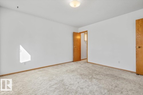 Light-colored carpeting with a neutral wall palette - 4427 Payne Avenue, Onoway, AB - Indoor Photo Showing Other Room