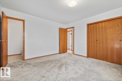 Neutral tone carpeting, light wood-finish doors, and white walls - 4427 Payne Avenue, Onoway, AB - Indoor Photo Showing Other Room