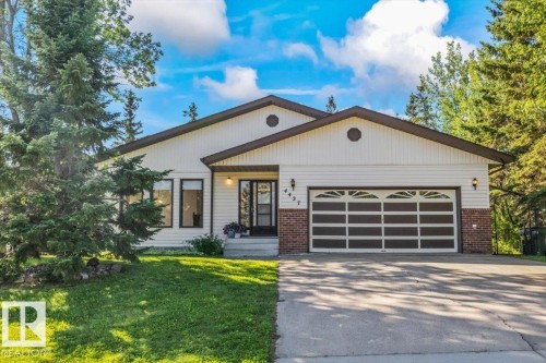 Siding exterior with brick accents, attached two-car garage, front entry with transom window, and established landscaping - 4427 Payne Avenue, Onoway, AB - Outdoor