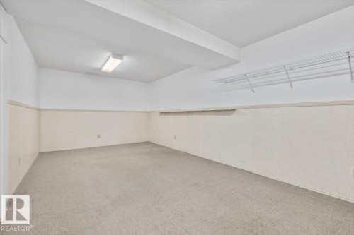 Carpeted floor, white walls with light beige wainscoting, and wire shelving - 4427 Payne Avenue, Onoway, AB - Indoor