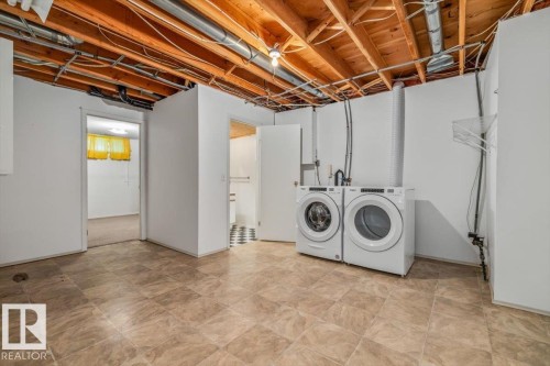 Tile flooring with exposed ceiling joists - 4427 Payne Avenue, Onoway, AB - Indoor Photo Showing Laundry Room