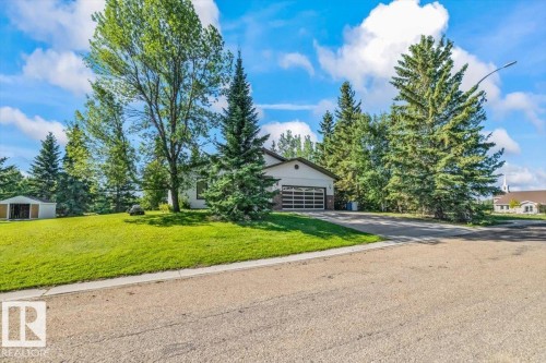 Single-story residence with an attached two-car garage featuring a glass-paneled door - 4427 Payne Avenue, Onoway, AB - Outdoor