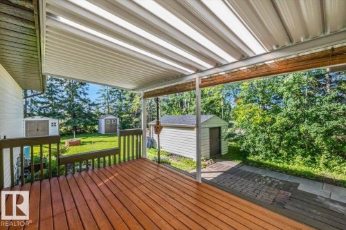 Covered deck with wood-finish flooring and railing - 4427 Payne Avenue, Onoway, AB - Outdoor With Deck Patio Veranda With Exterior