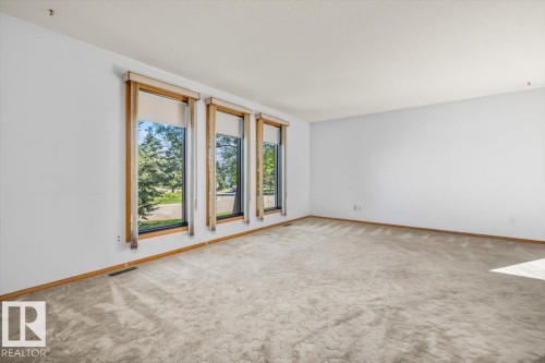 Expansive room featuring light-toned carpeting and white walls - 4427 Payne Avenue, Onoway, AB - Indoor Photo Showing Other Room