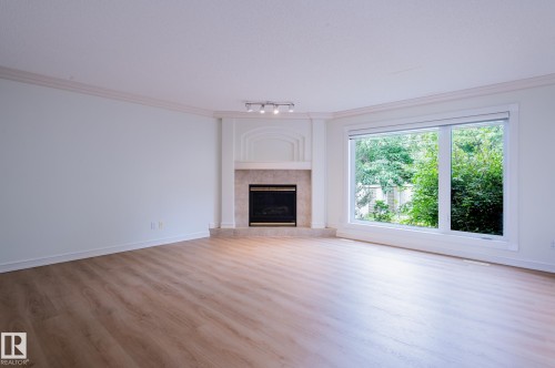 310 Livingstone Court Nw, Edmonton, AB - Indoor Photo Showing Living Room With Fireplace