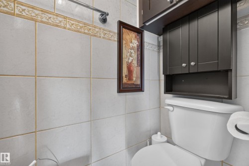 White square tile walls with decorative border - 23 Willowdale Place Nw, Edmonton, AB 