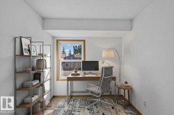 Bright interior space featuring wood-finish flooring, a double-hung window with wood trim, and painted walls - 