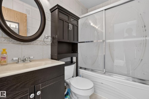 Vanity with integrated sink, chrome faucet, and dark wood-finish cabinetry - 23 Willowdale Place Nw, Edmonton, AB 