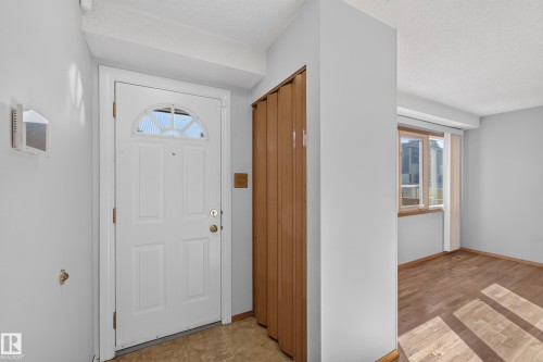 White paneled entry door with an arched window transom - 23 Willowdale Place Nw, Edmonton, AB 