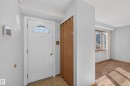 White paneled entry door with an arched window transom - 23 Willowdale Place Nw, Edmonton, AB 