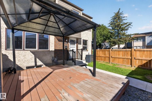 Private deck with an overhead gazebo structure, fenced yard, and exterior stucco finish - 23 Willowdale Place Nw, Edmonton, AB 