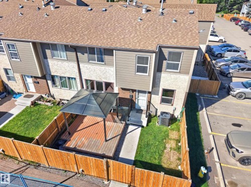 Backyard featuring a wood deck with a gazebo, manicured lawn, and wood fencing - 23 Willowdale Place Nw, Edmonton, AB 