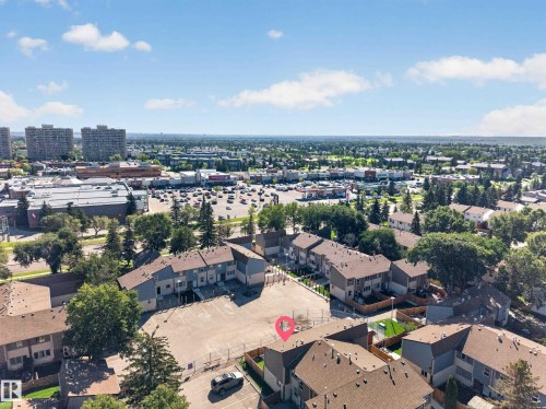 Townhome community with a large parking area, private fenced yards, and mature trees - 23 Willowdale Place Nw, Edmonton, AB 