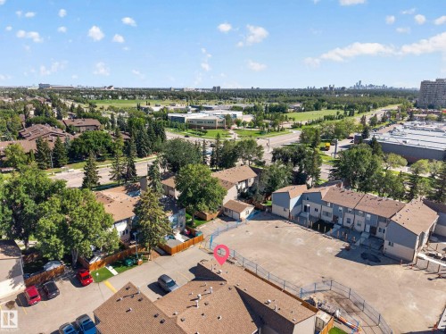 Expansive property featuring multiple residential structures with brown shingle roofing and light blue siding - 23 Willowdale Place Nw, Edmonton, AB 