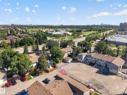 Expansive property featuring multiple residential structures with brown shingle roofing and light blue siding - 