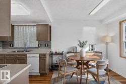Kitchen featuring wood-finish cabinetry, light-toned countertops, and a tiled backsplash - 