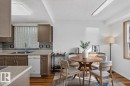 Kitchen featuring wood-finish cabinetry, light-toned countertops, and a tiled backsplash - 23 Willowdale Place Nw, Edmonton, AB 