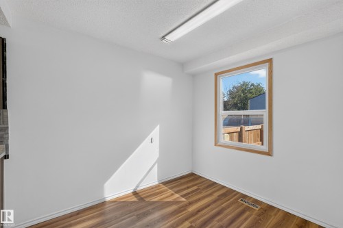 Wood-finish flooring, white walls, and a wood-trimmed window - 23 Willowdale Place Nw, Edmonton, AB 