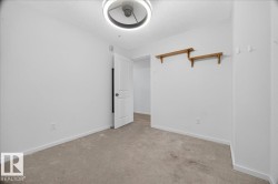 Neutral-toned carpeting complements the white wall finish - 