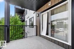 Private balcony featuring concrete flooring and black metal railings - 