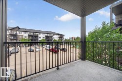 Private concrete balcony with black metal railings, offering an exterior-facing perspective - 