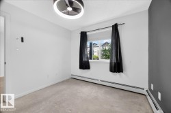 Windowed room featuring wall-to-wall carpeting and a modern ceiling light fixture - 