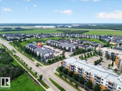Aerial perspective showcasing a multi-unit residential building with multiple balconies and exterior parking - 