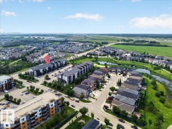 Aerial perspective showcasing a residential development with multi-story buildings and single-family homes - 