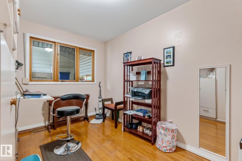 Hardwood-finish flooring, built-in shelving, and a large window with natural wood trim - 13432 134 Street Nw, Edmonton, AB - Indoor