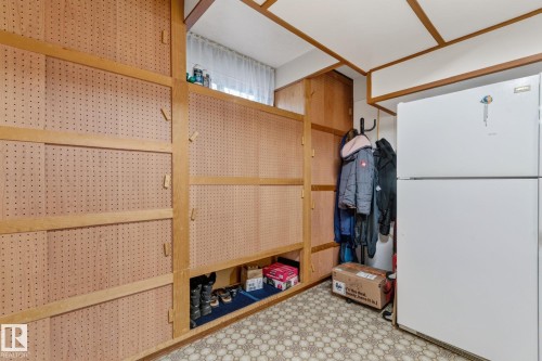 Built-in pegboard storage units with wood framing and a patterned floor - 13432 134 Street Nw, Edmonton, AB - Indoor Photo Showing Laundry Room