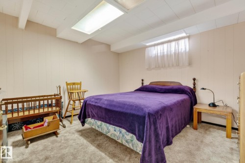Recessed ceiling lighting, exposed ceiling beams, paneled wall finish, window with white curtain, and carpeted flooring - 13432 134 Street Nw, Edmonton, AB - Indoor