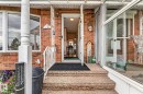 Brick exterior with bay window, white porch columns, white metal railing, and textured concrete steps - 13432 134 Street Nw, Edmonton, AB  - Outdoor 