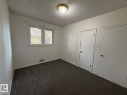 Interior room featuring carpet flooring, white walls, and a window with white trim - 