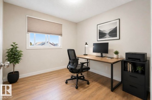 Recessed ceiling light, wood-finish flooring, neutral wall paint, and a white framed window with a cellular shade - 21207 90 Ave Nw, Edmonton, AB - Indoor Photo Showing Office