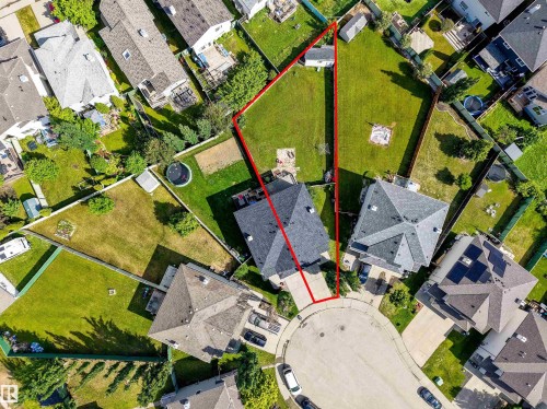 Aerial view of property featuring a cul-de-sac location, paved driveway, detached garage, and expansive lawn - 21207 90 Ave Nw, Edmonton, AB - Other
